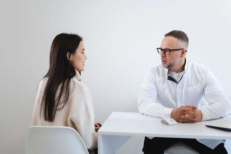 Young woman at the doctor's appointment. Doctor giving advice to female patientの写真素材