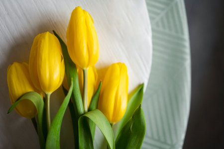 Yellow tulips on the table. Fresh spring flowersの写真素材
