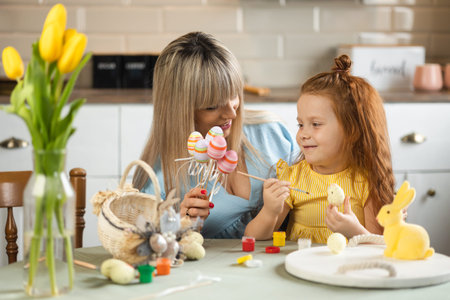 Happy mother and daughter are preparing for Easter