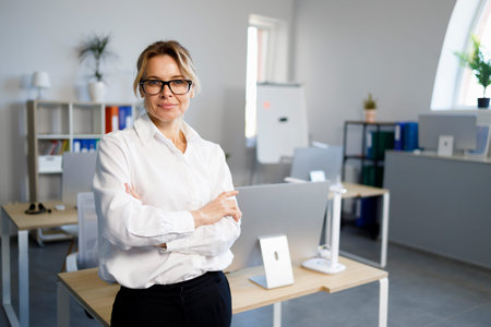 Portrait of confident businesswoman with arm crossed in office