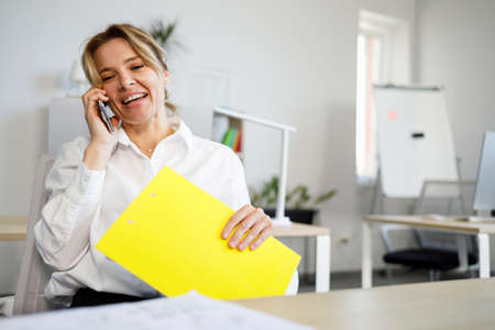 Portrait of a businesswoman talking on the mobile phoneの写真素材