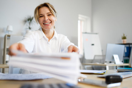 Portrait of cheerful business woman giving document