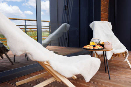 Terrace with chairs and a table with foodの写真素材