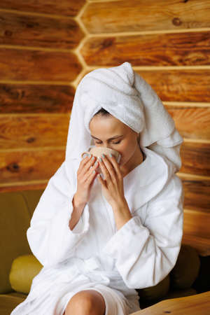 Portrait of woman drinking tea after spa treatmentsの写真素材