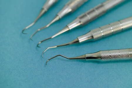 Close-up view of periodontal scalers lying on a blue backgroundの写真素材