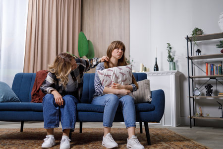 Mature woman soothes her adult daughter helps her survive or break up. Mom supporting provide psychological aid show empathy. First love of female teenager, mother give wise adviseの写真素材