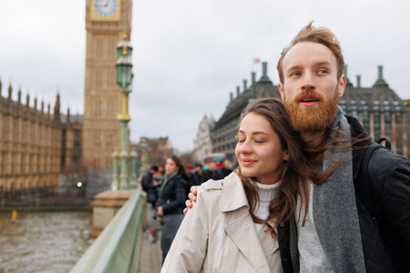 Couple stands in an embrace near Big Ben in Londonの写真素材