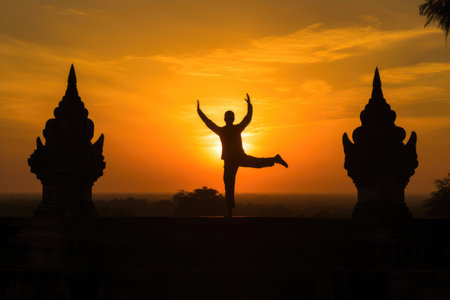 Tranquil Yoga Pose at Dusk in a Historic Templeの素材