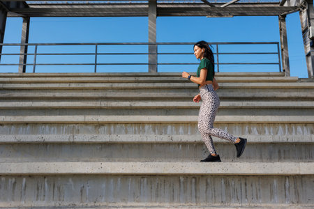 Young Female Runner Exercising in Athletic Stadiumの写真素材