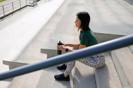 Stepside Serenity: Athletic Woman's Pause