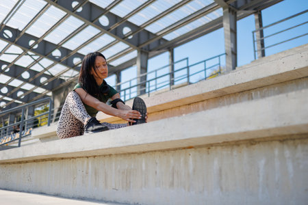 Exercise and Stretching on Yoga Mat in Stadium Settingの写真素材