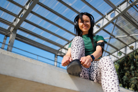 Healthy Lifestyle: Woman Prepping for Jog in Stadiumの写真素材