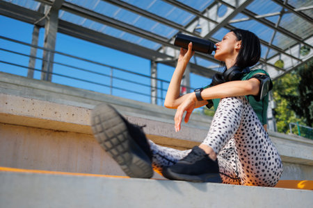 Brunette Athlete Quenching Thirst During Workout