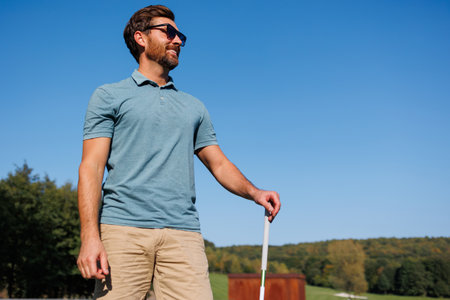 Young Man Ventures into Golfing Delightの写真素材