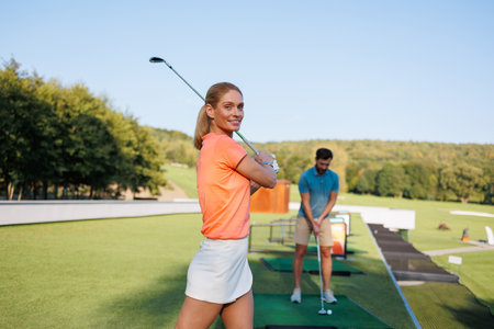 Dynamic Golfing Duo: Couple's Tee Timeの写真素材