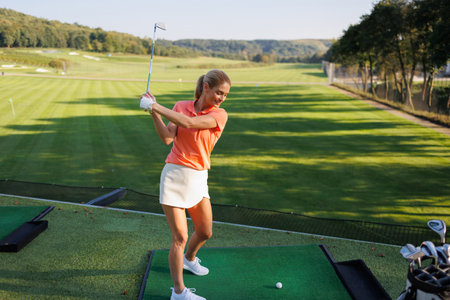 Graceful Female Golfer on Fairwayの写真素材