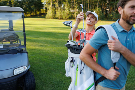 On-Course Interaction: Woman Picks Club from Partner's Bagの写真素材