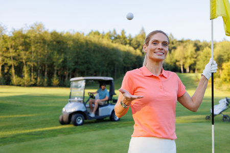Celebrating Triumph: Woman with Water at Final Hole, Man on Golf Cartの写真素材