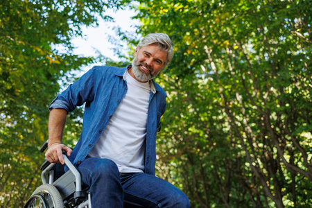 Pushing Boundaries: Resilient Man in Wheelchair Rises Upの写真素材