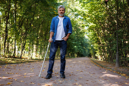 Solitary Figure: A Man Leaning on a Crutchの写真素材