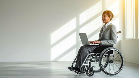 Successful Businesswoman in Wheelchair Working in Minimalist Officeの素材