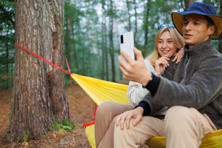 Chilled Out Couple in Hammock with Phone Video Callの写真素材