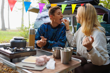 Scenic Break: Couple with Minivan and Marshmallow Treats in Nature