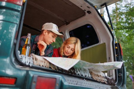 Couple with map enjoying van life in nature