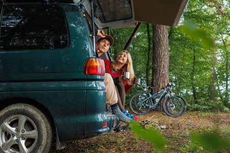 Couple Relaxing with Tea in Travel Van