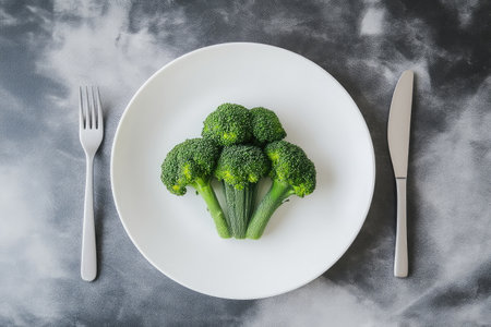 Green Broccoli on White Plate with Stylish Cutleryの素材