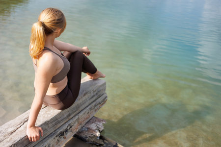 Active Lifestyle: Girl Resting by the Lakeshoreの写真素材