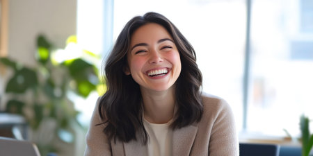 Cheerful Office Environment with a Laughing Colleagueの素材