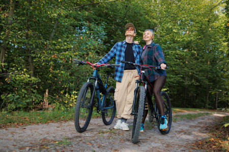 Couple while riding bicycles looking at the nature aroundの写真素材