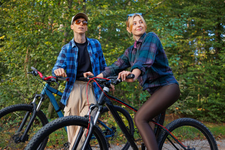 Couple while riding bicycles looking at the nature aroundの写真素材