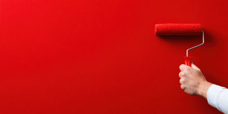Hand Painting Wall with Red Paint and Rollerの素材