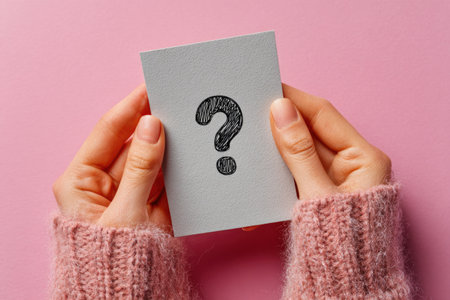 Hands in Pink Sweater Holding Question Mark Cardの素材