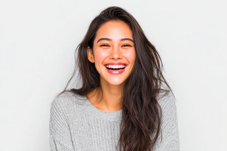 Joyful Woman Laughing in Cozy Sweaterの素材