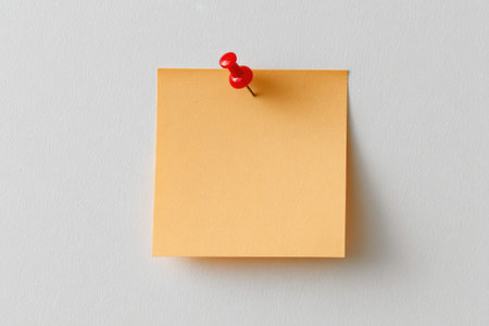 Red pushpin on blank pastel noteの素材