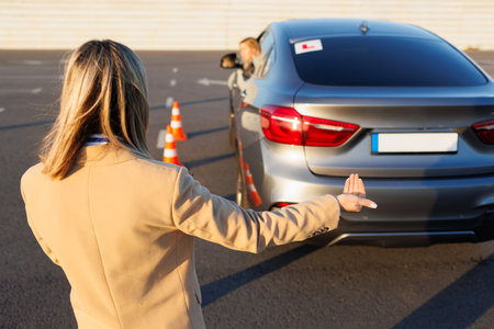 Driving Instructor Signaling During Reverse Parking Exerciseの写真素材