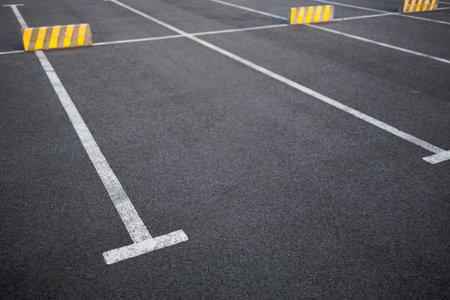 Empty Parking Lot with Fresh White Markings on Asphalt Surfaceの写真素材
