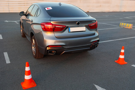 Driving School Car Positioned Between Cones on Practice Parking Areaの写真素材