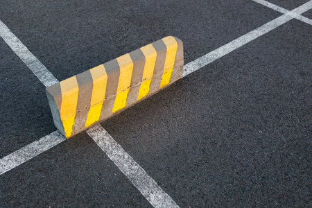 Parking Stop Barrier on Marked Asphalt Surface at Driving Courseの写真素材