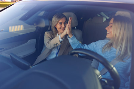 Celebrating Driving Test Success â Student Driver and Instructor Exchange High-Fiveの写真素材