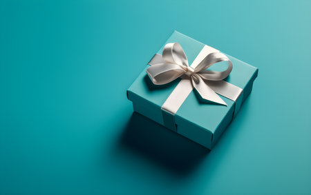 Blue gift box with a white bow on a turquoise background, Generative AIの素材