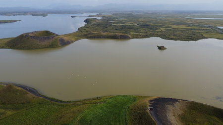 Aerial view of a lake in the middle of a meadowの写真素材