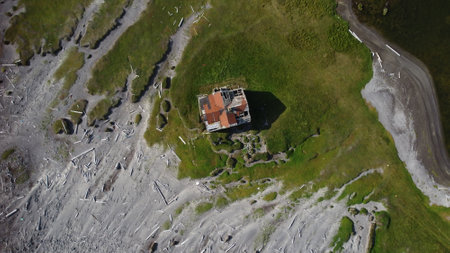 Aerial view of a small house in the middle of the mountainsの写真素材