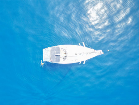 Aerial view of a boat floating in the sea with blue skyの写真素材