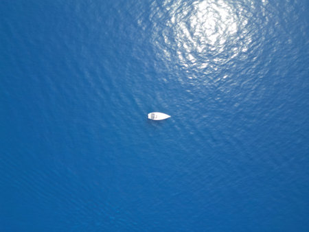 Aerial view of a boat floating on the water surface in the seaの写真素材