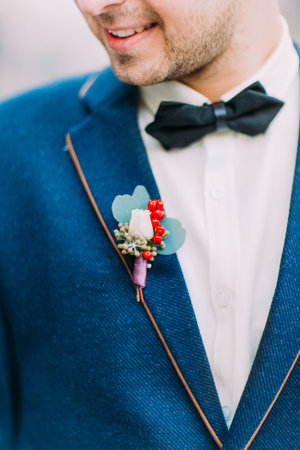 Vintage wedding boutonniere on the groom's suit close up.
