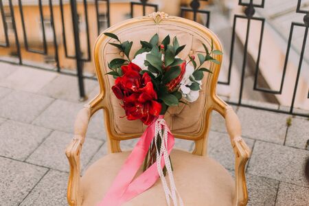 Beautiful wedding bouquet on the vintage beige chair.の写真素材